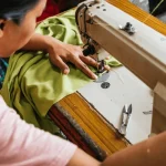 asian seamstress skillfully sewing green 600nw 2601100815