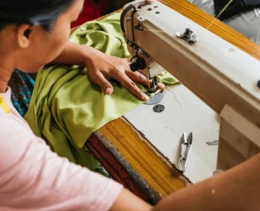 asian seamstress skillfully sewing green 600nw 2601100815