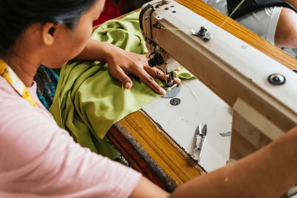 asian seamstress skillfully sewing green 600nw 2601100815